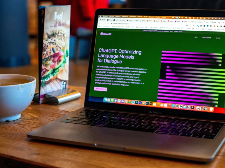 A laptop on a table showing the chatgpt home screen