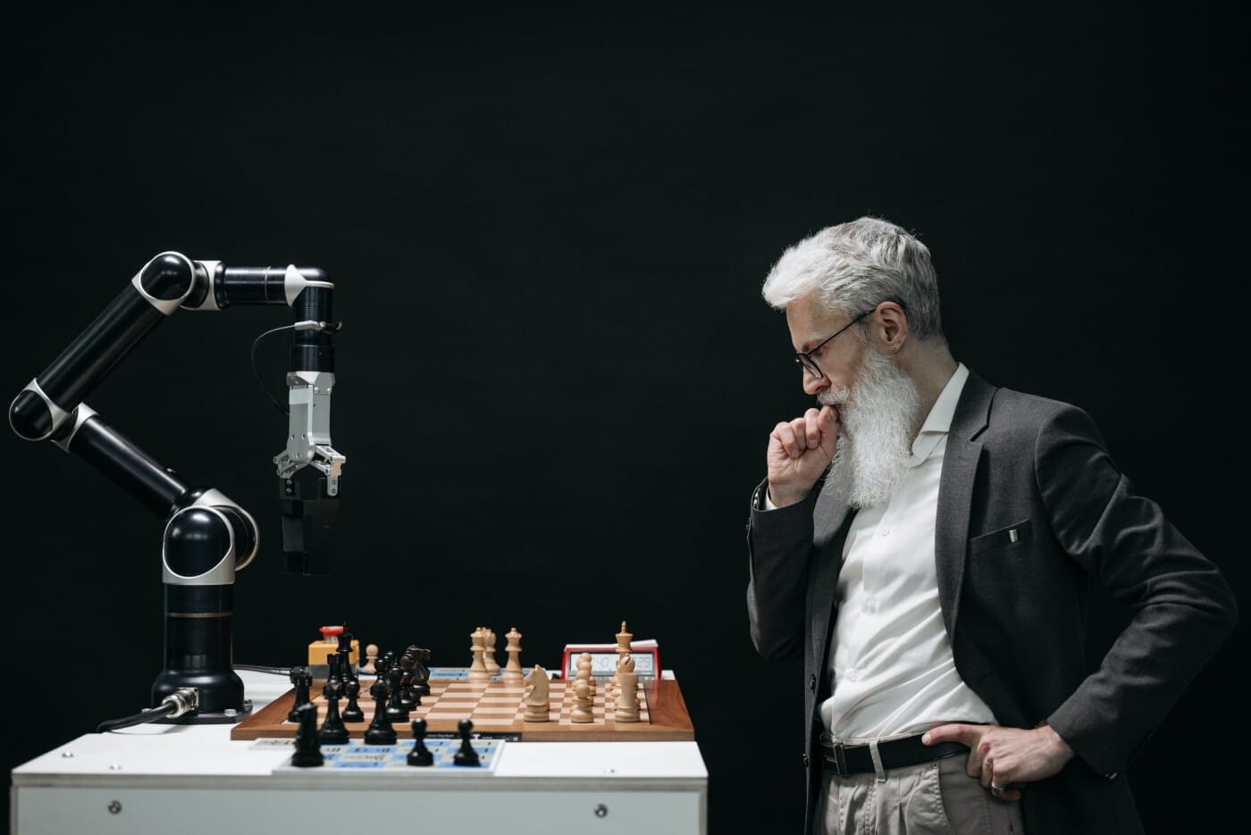 Ai Is Disrupting Industries-How Should You Face This Impact Of Ai? 1 An elderly man thinking while looking at a chessboard